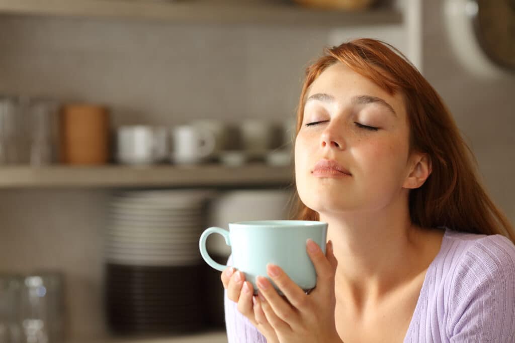 Woman Relaxing Drinking Coffee In The Kitchen