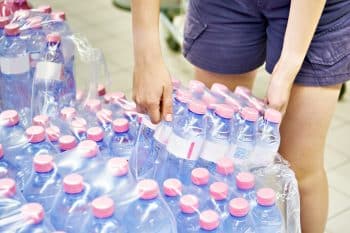 Customer With Pack Of Water Bottles