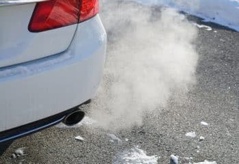 Close Up On Smoke From Car Pipe Exhaust In Winter Season