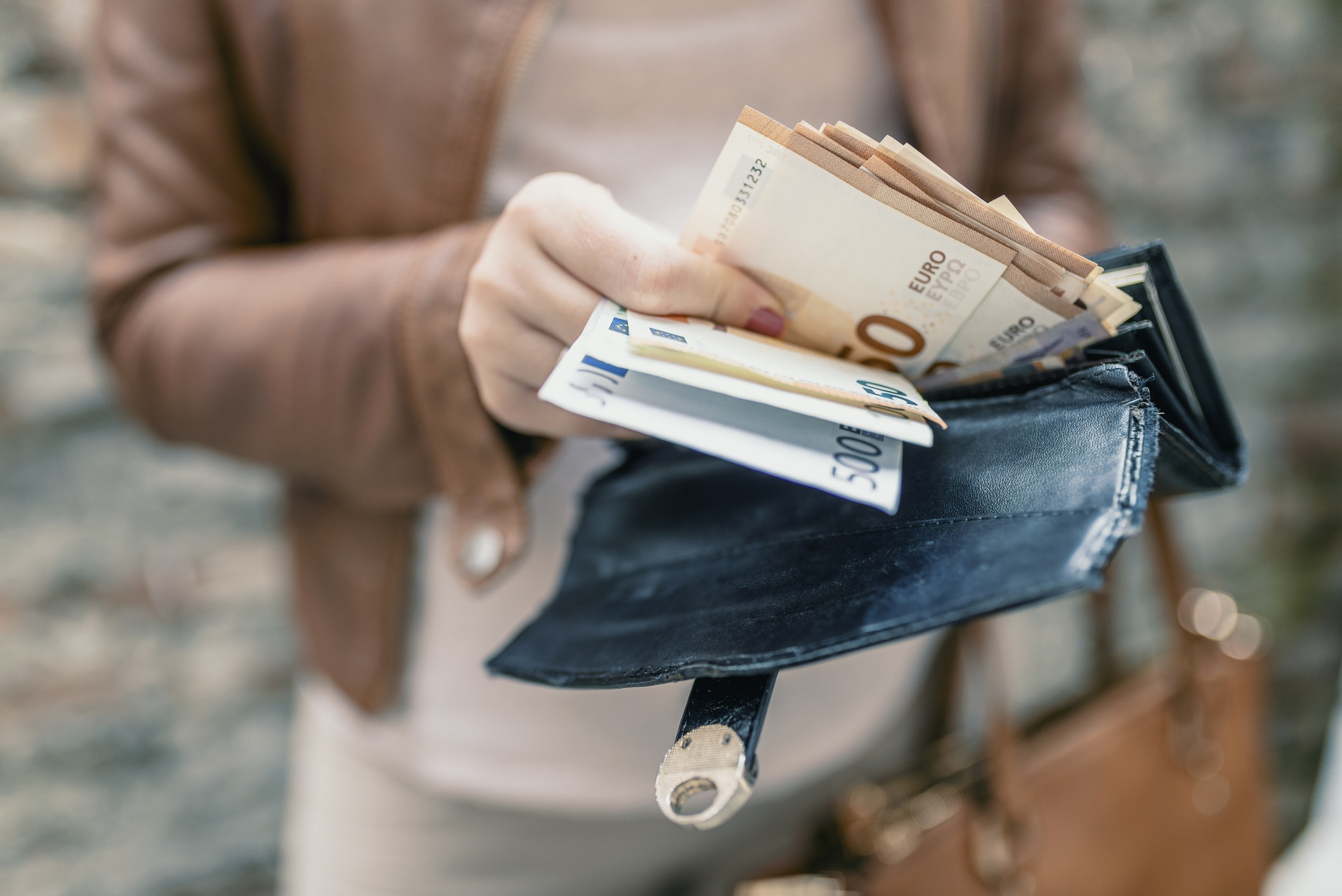 Woman Holding In Hands Wallet With Euro Money. City Girl Is Taking Out Money From Wallet