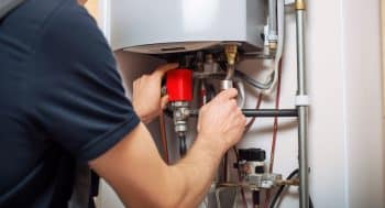 Hydraulic Mechanic Installer Repairs An Electric Water Heater