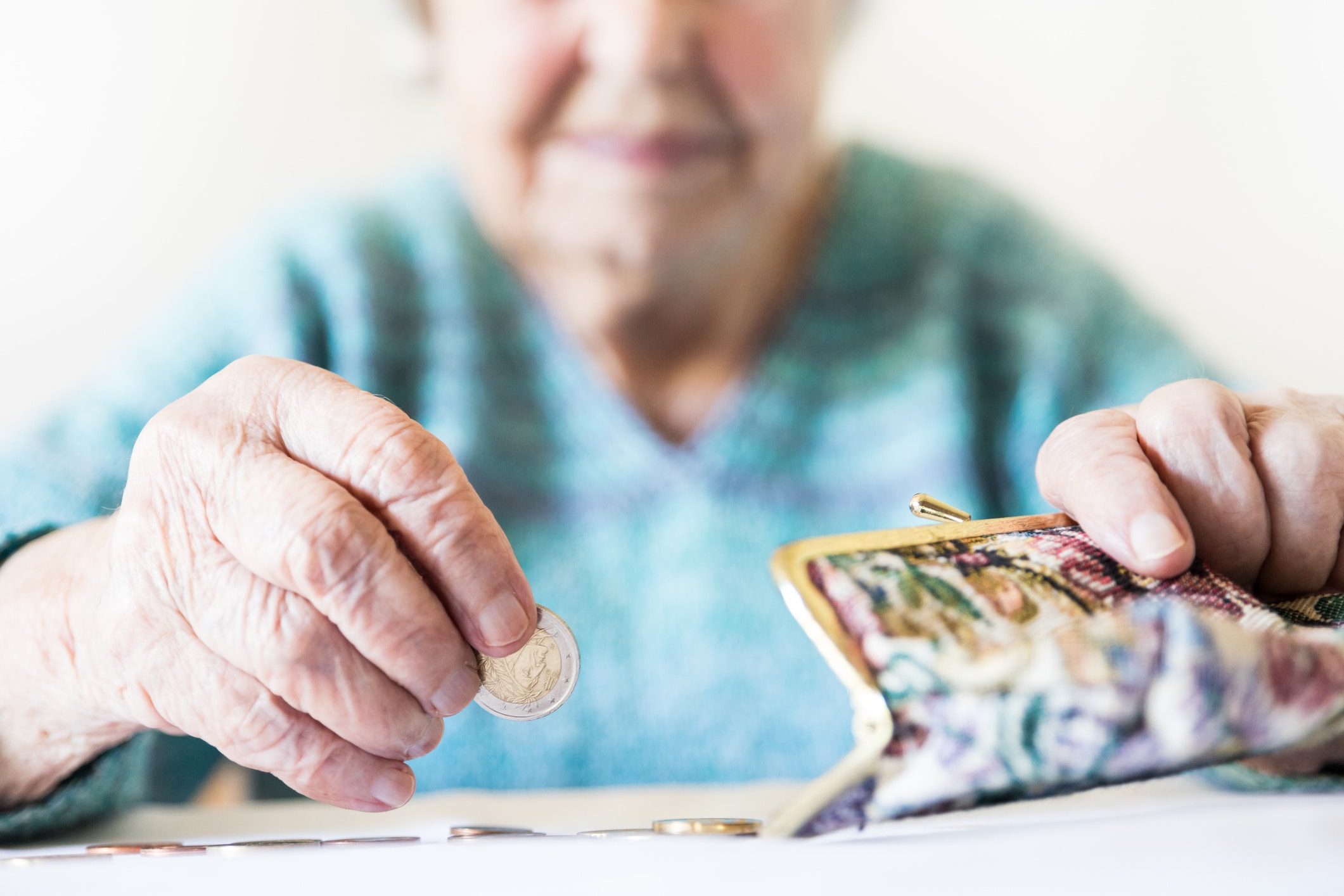 Detailed Closeup Photo Of Unrecognizable Elderly Womans Hands Counting Remaining Coins From Pension In Her Wallet After Paying Bills.