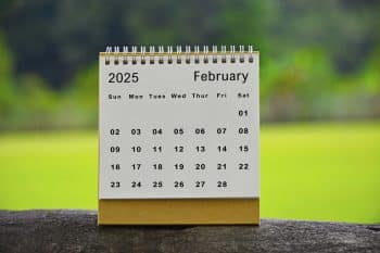 February 2025 White Calendar With Green Blurred Background New Year Concept