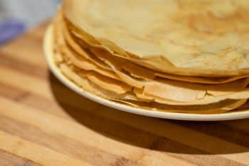 Close Up Of A Tasty Yellow Crepes With Crispy Edges On A White Plate