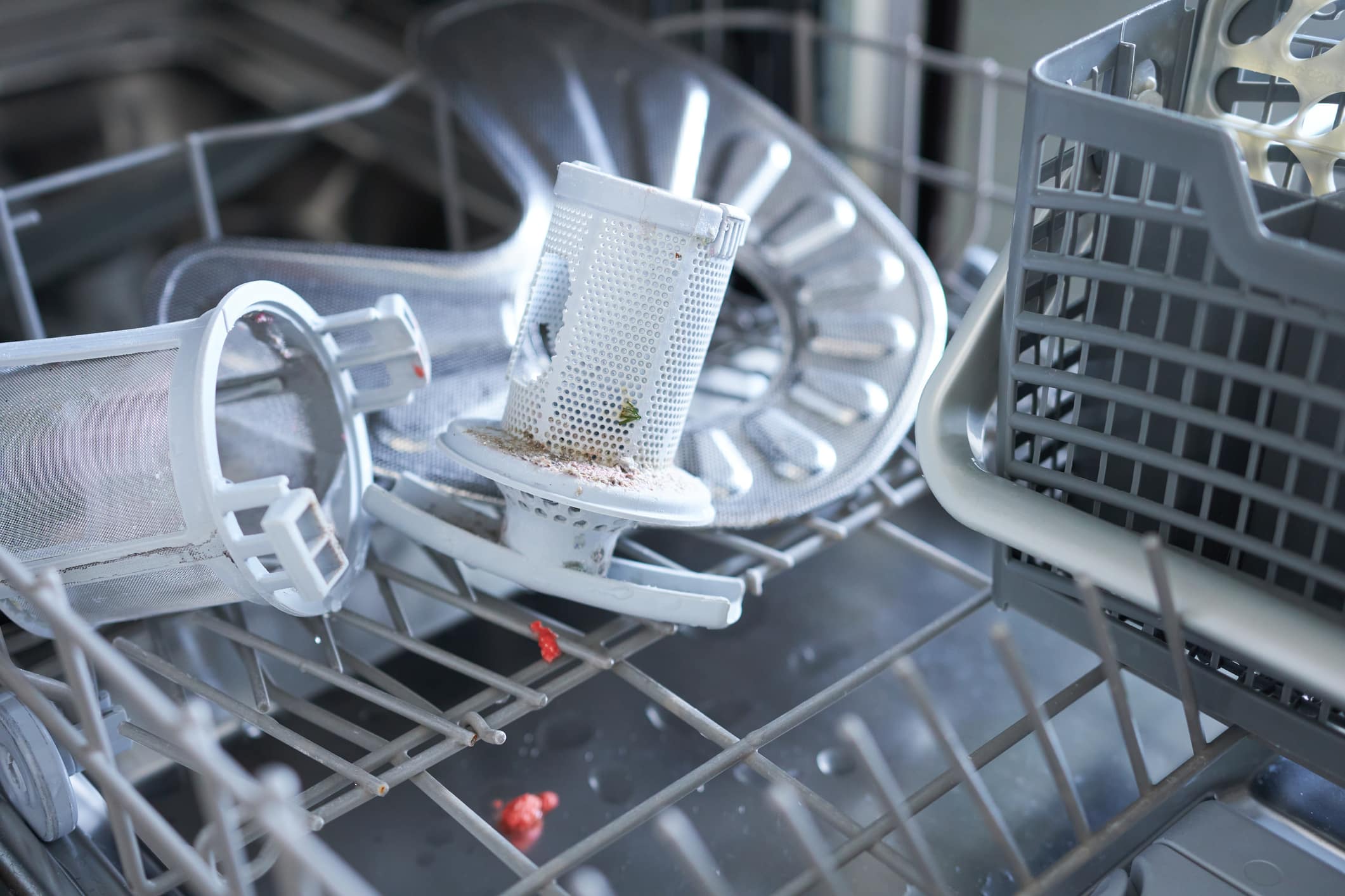 A Broken Dishwasher With The Door Open.