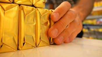 Close Up Of Butter Packagings On A Supermarket Fridge Shelf And A Male Buyer's Hand Takes One