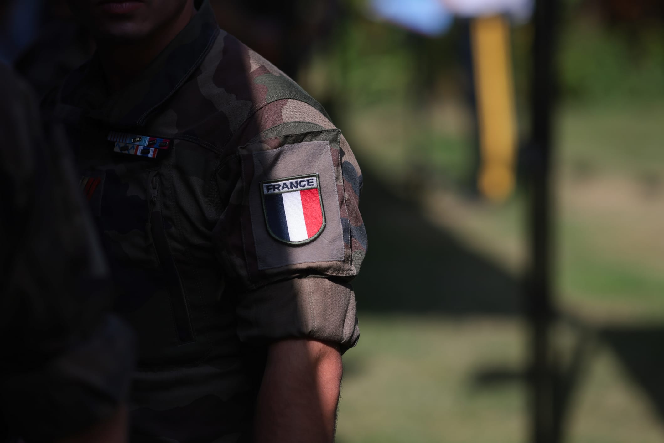 Shallow Depth Of Field (selective Focus) Details With The French Flag On The Military Uniform Of A Soldier