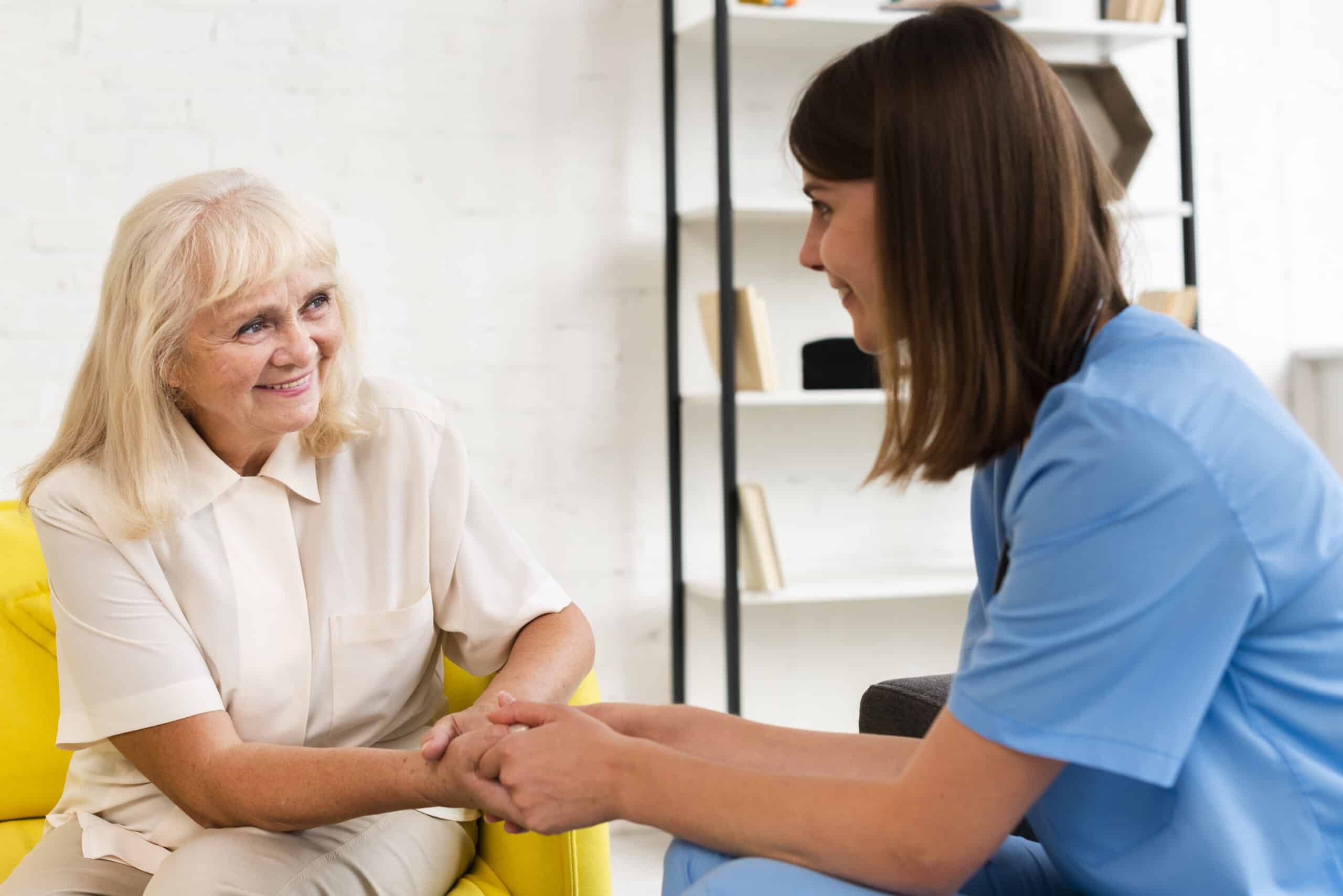 Medium Shot Old Woman Nurse Holding Hands