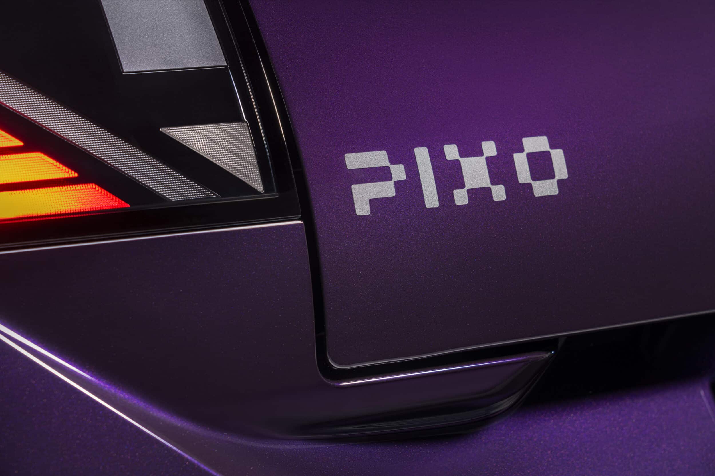 Close-up of the Nissan PIXO rear light cluster and PIXO badge on the purple bodywork.